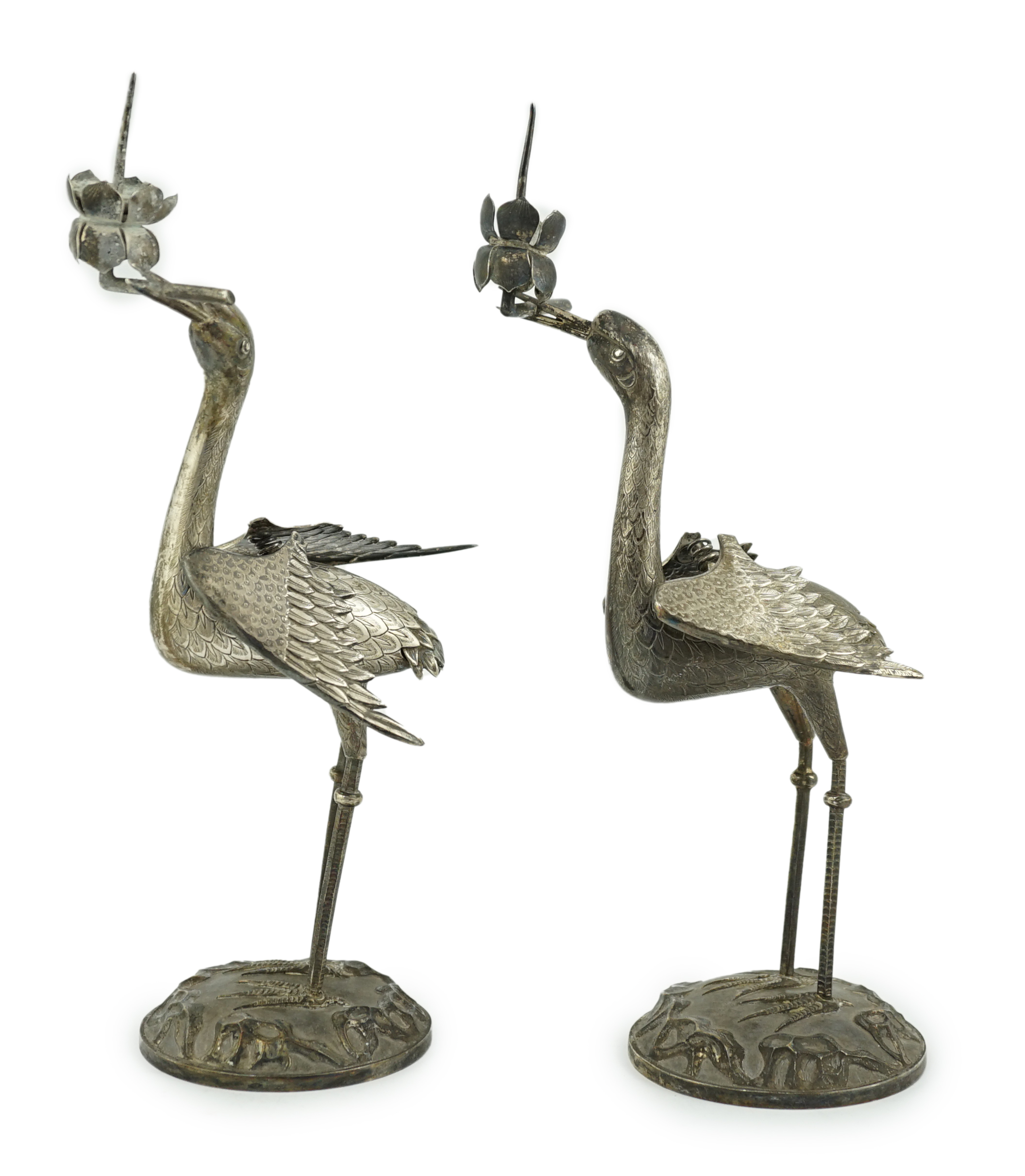 A pair of early to mid 20th century Japanese silver candlesticks, modelled as cranes